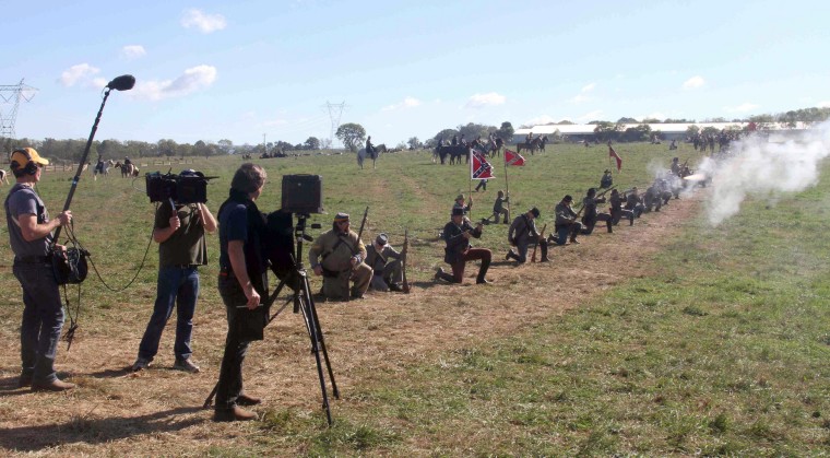 A camera crew from Rock Center films photographer Richard Barnes, working in the field during a reenactment of the Battle of Antietam in Sharpsburg, Md.